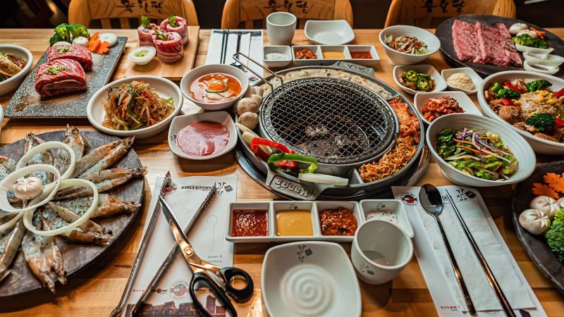 A Korean barbecue table laid out for a group, with the grill set in the centre